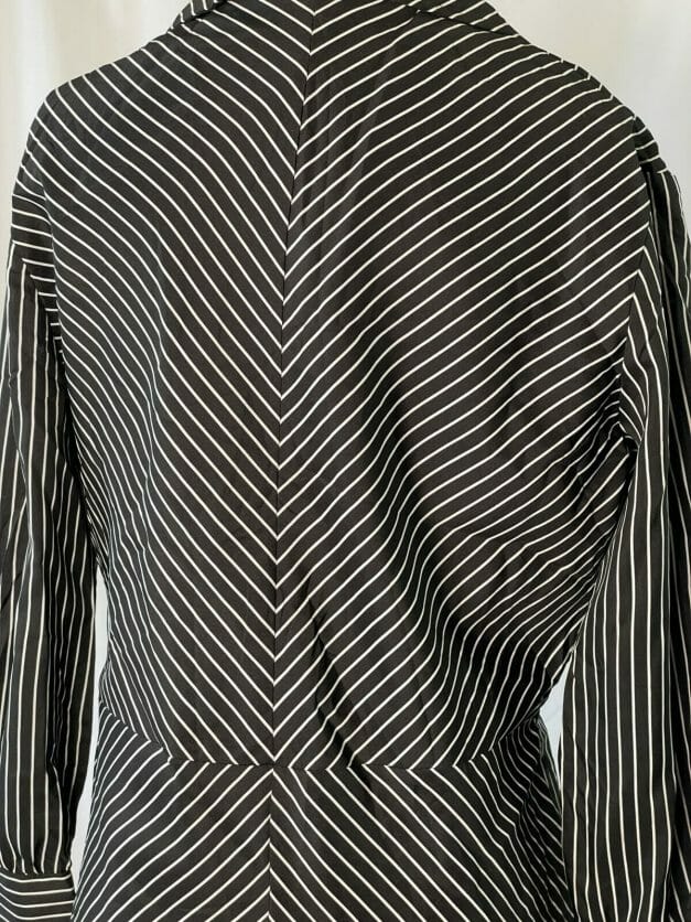 A cute classic long sleeve vintage pinstripe dress on a mannequin.