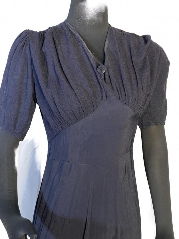 The Dainty Blue 1930s Vintage Dress elegantly showcases a dainty blue dress.