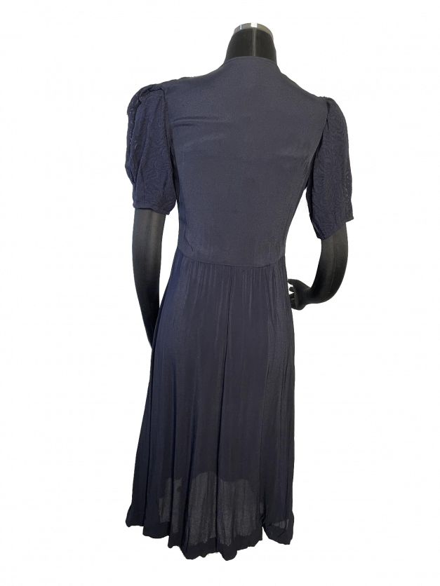 A dainty mannequin wearing a Dainty Blue 1930s Vintage dress.