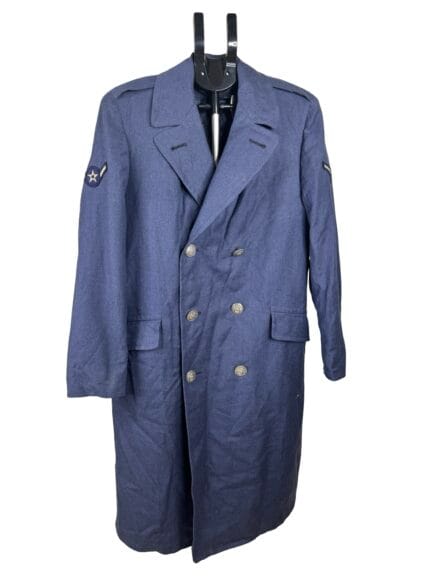 A Vintage USAF Air Force Blue Wool Overcoat 37R with silver buttons and double breasted design (8405-939-7803) hangs neatly on a black hanger.