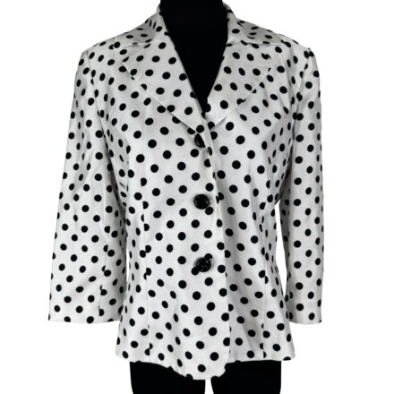 The Vintage 90s Kasper Polka Dot Blazer Jacket—The Ultimate Pinup Office Essential—features white fabric with black spots, wide lapels, and two black buttons, stylishly showcased on a mannequin.