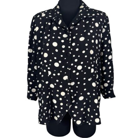 Vintage 80s Black Polka Dot Blouse with white spots, styled on a black mannequin torso, evokes classic pinup and rockabilly fashion.