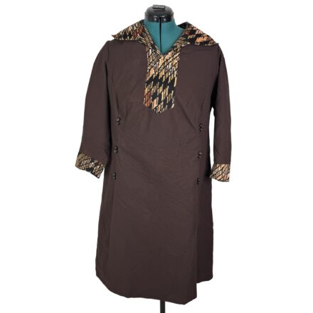 70s brown plus size Art Deco dress with geometric polyester print, long sleeves, double-breasted buttons, on dress form.