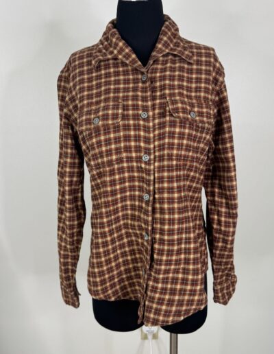 Vintage 90s Levi's brown plaid flannel shirt on black dress form with two chest pockets, dagger collar, white background.