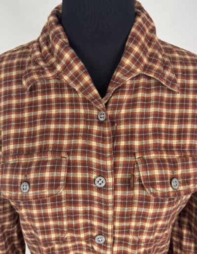 Vintage 90s Levi's women's brown plaid flannel shirt with dagger collar, chest pockets, silver buttons; retro grunge style.