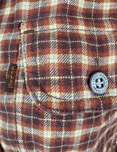 Vintage 90s Levi's women's flannel shirt, brown red cream plaid, front pocket, black button, yellow seam tag, dagger collar.