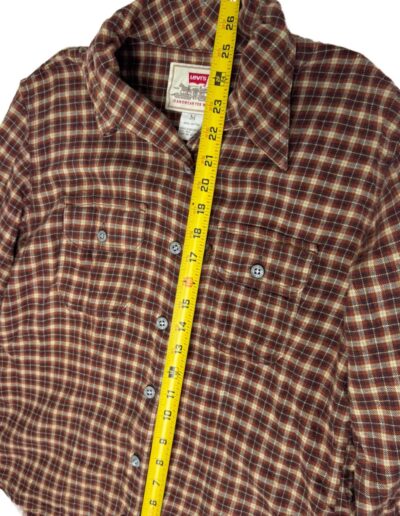 Vintage 90s brown Levi's plaid flannel shirt, medium, with dagger collar, laid flat and measured at 24 inches by yellow tape.
