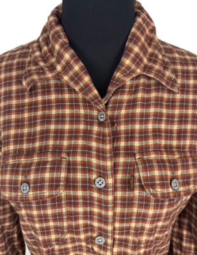 Vintage 90s Levi's women's plaid flannel shirt in brown, red, and cream with dagger collar and two chest pockets on mannequin.