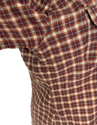 Vintage 90s Levi's brown plaid flannel shirt, size medium, side view highlighting underarm and chest pocket on white background.