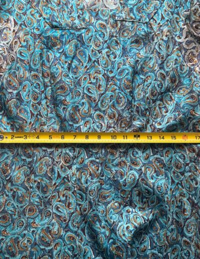 Yellow tape measure at 20 inches over blue and brown swirl-print 1940s Clayton New York short sleeve rayon dress.