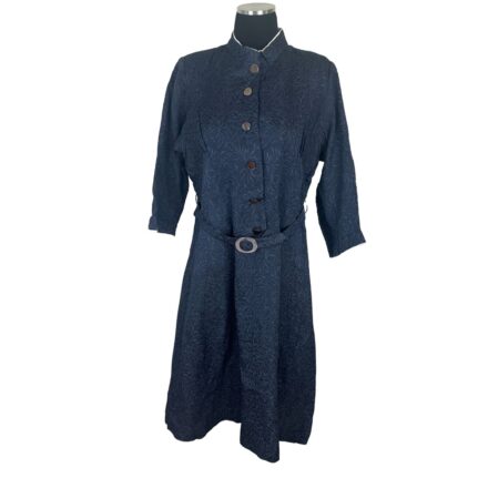 1940s navy blue floral brocade midi dress with mother of pearl buttons, original belt, and long sleeves on mannequin.
