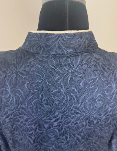 1940s handmade navy blue floral brocade midi dress back, textured pattern on black mannequin, vintage WWII style.