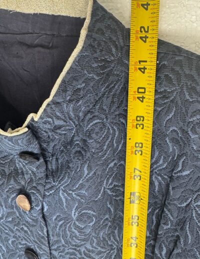 Vintage navy blue floral brocade WWII era midi dress with mother of pearl buttons and belt on mannequin; 41-inch length shown.