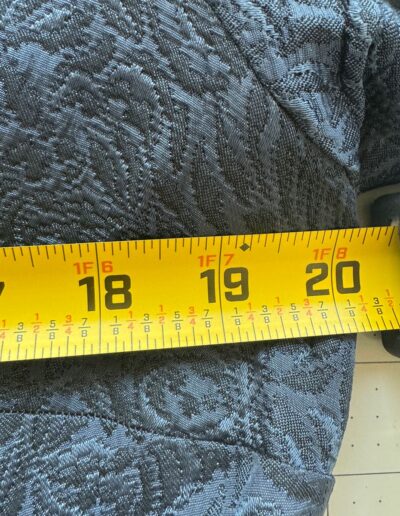 Yellow tape measure across navy blue floral brocade fabric, 19-inch mark at edge on 1940s handmade WWII era midi dress.