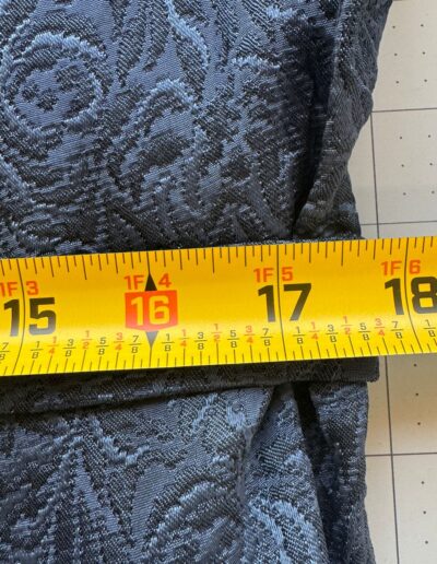 Navy blue floral brocade fabric measured at 16 inches with yellow tape, ideal for a 1940s Handmade Navy Blue Floral Brocade Midi Dress.
