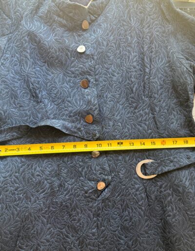 1940s navy blue floral brocade midi dress with mother of pearl buttons, original belt, and 21-inch width shown by yellow tape.
