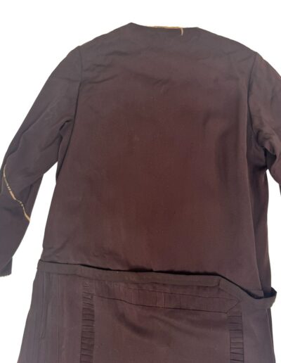Plus size 1920s dark brown Art Deco drop waist dress with pleated hem, visible seams, and frayed cuffs; XL/1X flapper style.