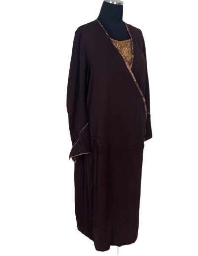 Plus size antique 1920s dark brown drop waist flapper dress with Art Deco embroidered neckline and brown trim on mannequin.