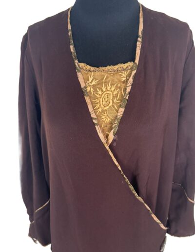 Rare plus size 1920s dark brown drop waist dress with gold floral brocade panel and Art Deco embroidery on black mannequin.