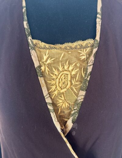 Plus size antique 1920s dark brown drop waist flapper dress with gold Art Deco embroidery, lace trim, and V-neckline.