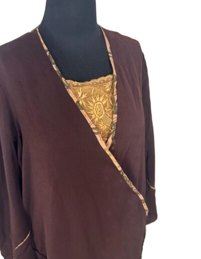 Plus Size Antique 1920s dark brown drop waist dress with gold Art Deco embroidery, long sleeves, and patterned trim on mannequin.