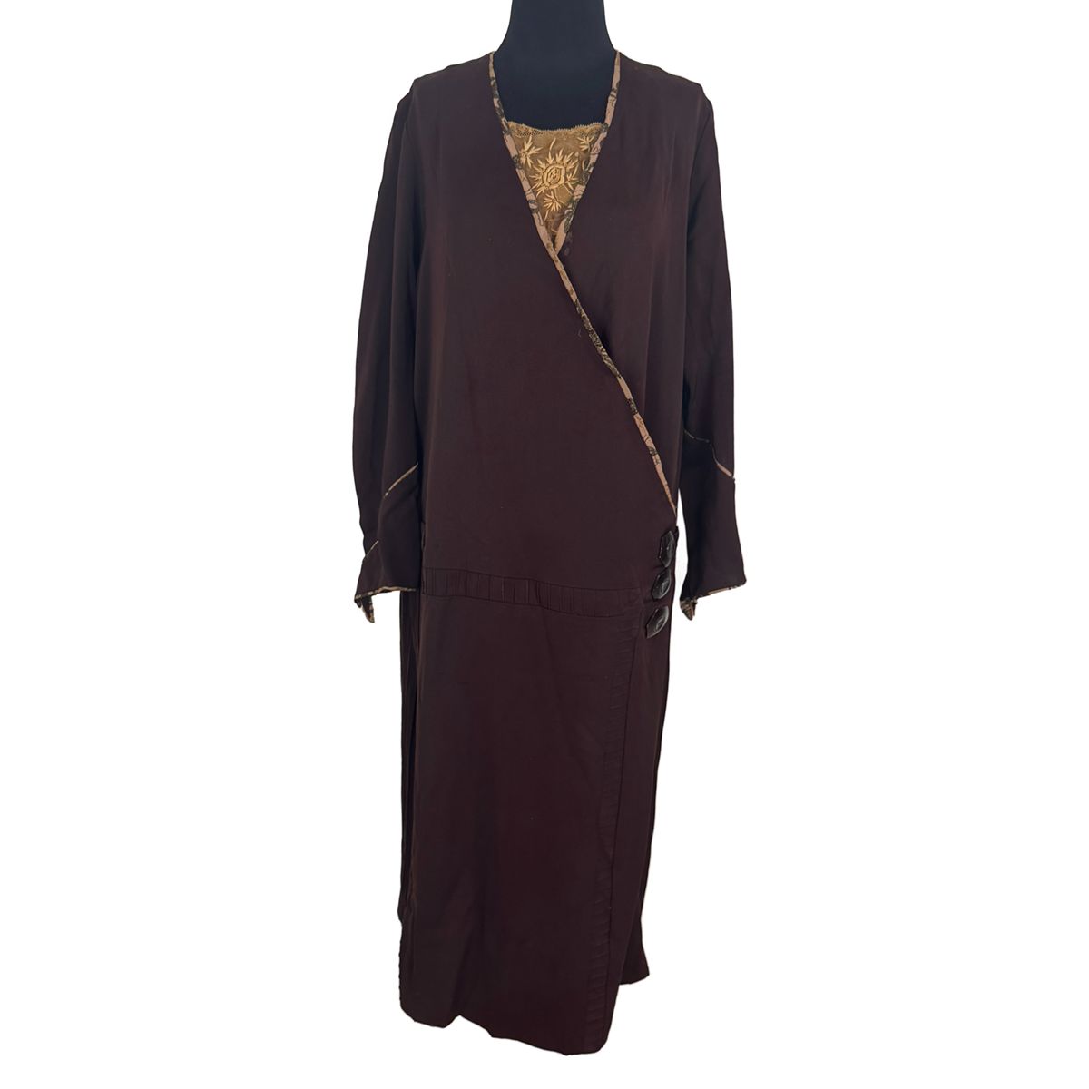 Plus size antique 1920s dark brown drop waist flapper dress with gold floral art deco embroidery, long sleeves, on black mannequin. Plus size antique 1920s dark brown drop waist flapper dress with gold floral art deco embroidery, long sleeves, on black mannequin.