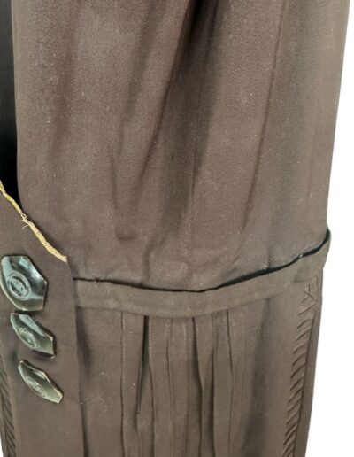 1920s plus size dark brown drop waist dress sleeve with three black buttons, pleats, and visible vintage edge wear.