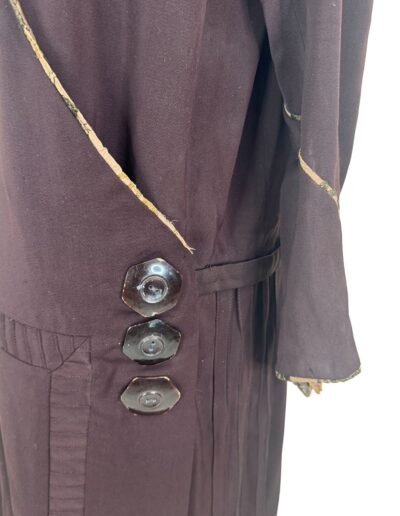 1920s plus size dark brown drop waist dress with art deco embroidery, frayed edges, hexagonal buttons, and detailed stitching.