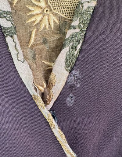 Plus size 1920s dark brown drop waist dress with V-neckline and gold-green Art Deco embroidered trim.
