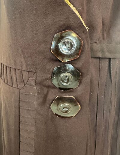 Rare plus size antique 1920s dark brown drop waist dress with Art Deco embroidery, hexagonal buttons, and vertical stitched accents.