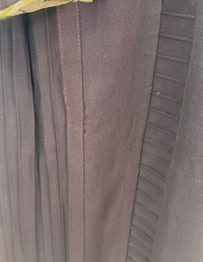 Dark brown fabric of Rare Plus Size Antique 1920s Drop Waist Dress with stitched seams, pleats, and yellow Art Deco lining.