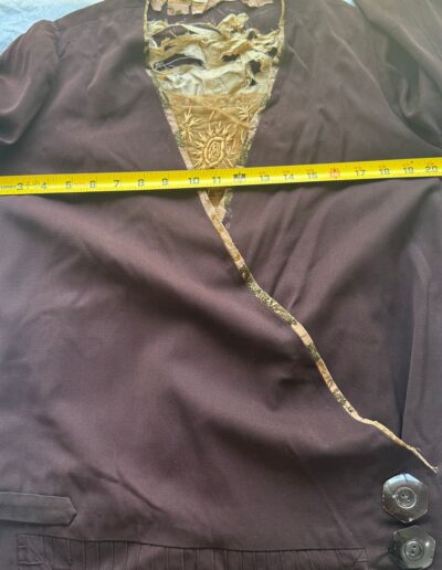Plus size antique 1920s dark brown drop waist dress with Art Deco embroidery, laid flat, yellow tape showing 19-inch chest.