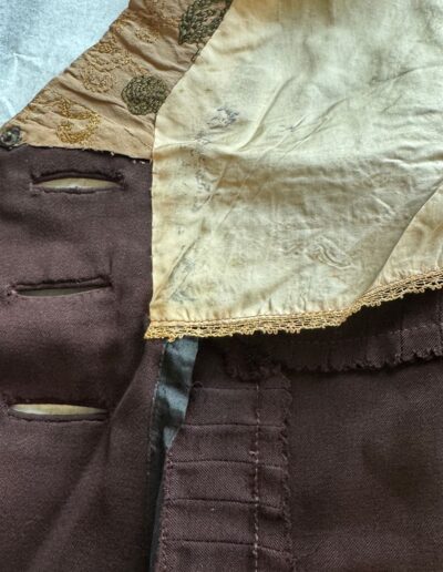 Rare plus size antique 1920s dark brown drop waist dress with worn fabric, lace-trimmed stained beige silk lining, and stitched buttonholes.