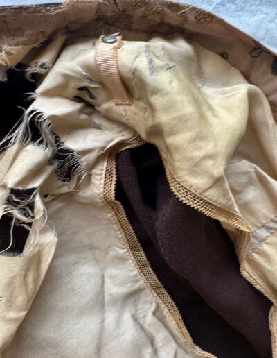 Tan jacket interior with frayed lining, exposed brown seams, and metal snap—Antique 1920s Art Deco plus size style.