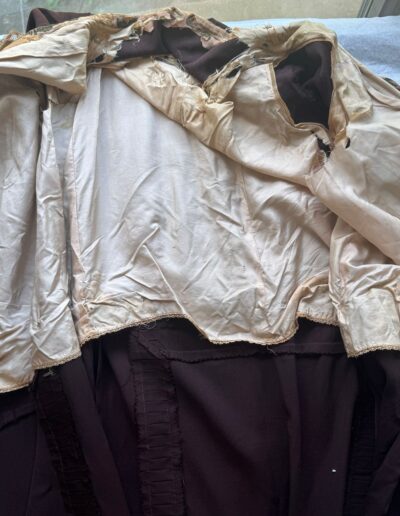 Rare plus size 1920s dark brown drop waist dress with Art Deco embroidery, torn beige lining visible underneath.