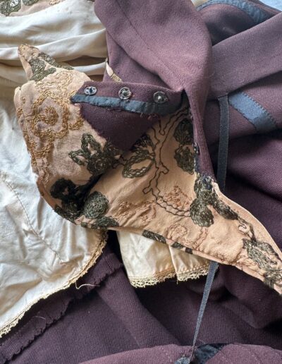 Antique 1920s plus size dark brown drop waist flapper dress with green and gold floral embroidery, beige lining, and textured fabric.
