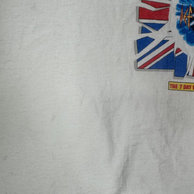 White cotton T-shirt with vintage Def Leppard concert tee style, features partial British flag, blue starburst, and THE 7 DAY text.