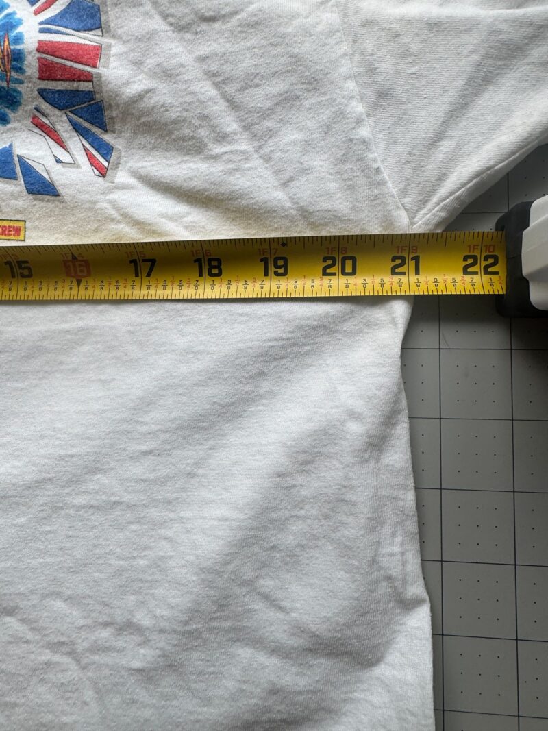 Vintage Def Leppard T-shirt in black cotton, 80s band style, measures 21 inches armpit to armpit on a gray grid surface.