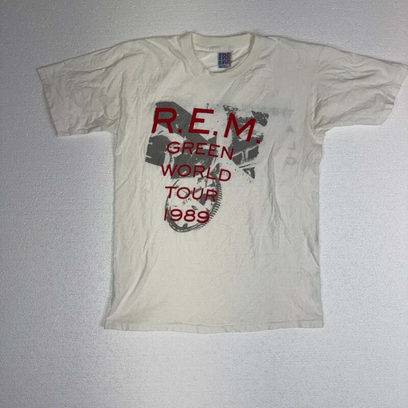 Vintage R.E.M. Green World Tour 1989 T-shirt, faded red and gray text on cotton, 1980s style, on a plain light background.