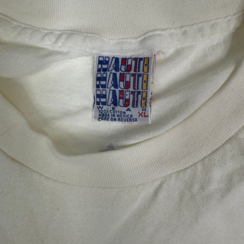 White cotton T-shirt tag in colorful block font, HAUTT logo, 1989 R.E.M. tour style, XL size, Made in Mexico.