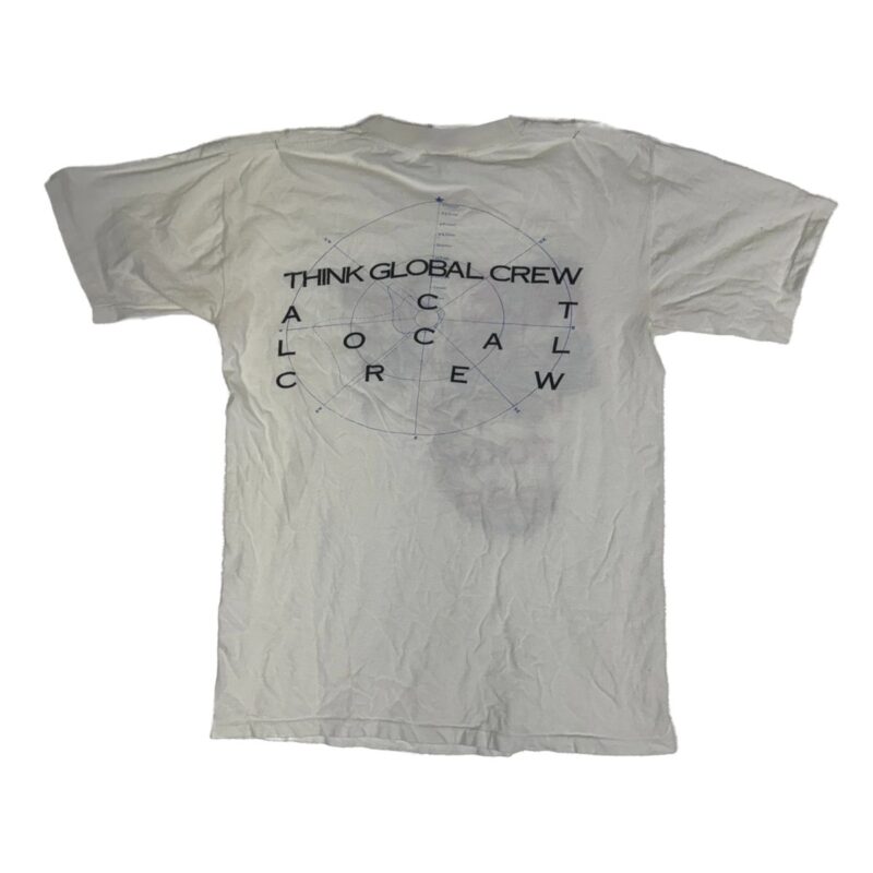 White cotton T-shirt with black globe graphic and THINK GLOBAL CREW, ACT LOCAL CREW text on back, 90s R.E.M. tour style, slightly wrinkled.
