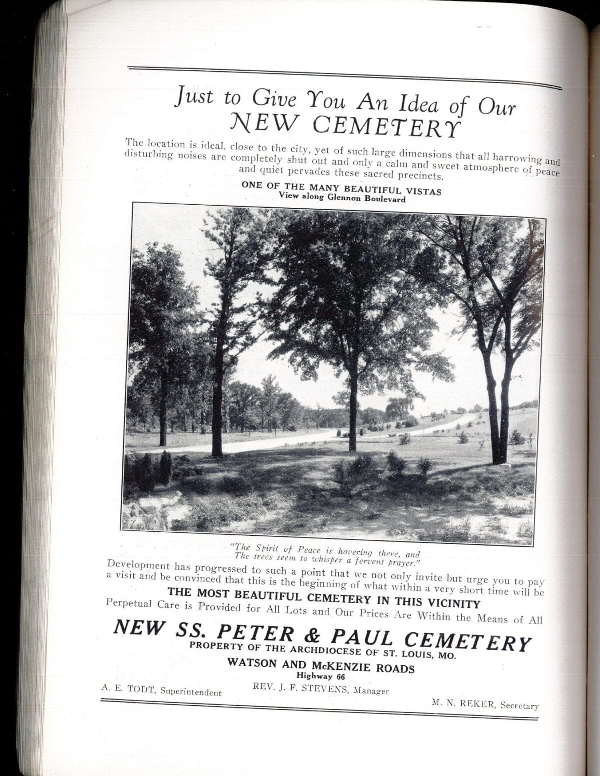 Black-and-white photo of a park-like cemetery with trees, grass, and a few people walking among monuments.