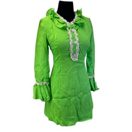 A Vintage 1960s Neon Green Mini Dress with sequin accents, made of Tricel 100% acetate, features long sleeves and is shown on a black mannequin torso.