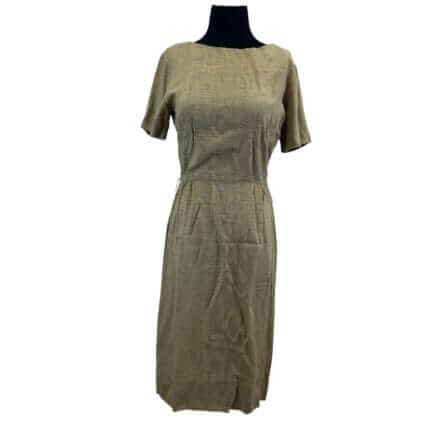 The 1970s Natural Linen Look Wiggle Dress is a knee-length, short-sleeve beige minimalist retro workwear piece with a fitted waist, shown on a black mannequin torso.