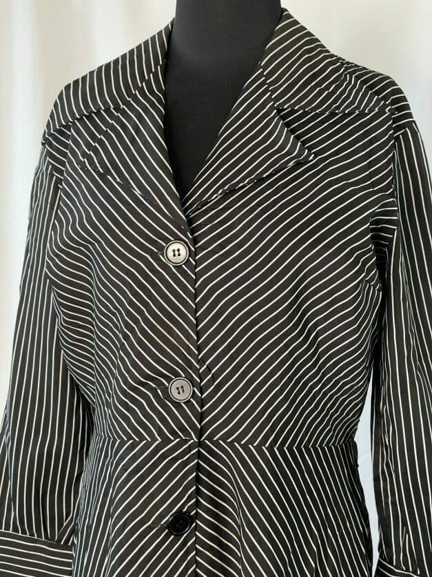 A cute classic long sleeve vintage pinstripe dress on a mannequin.