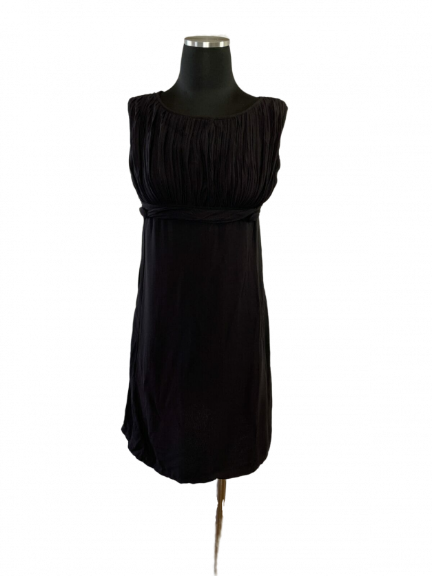 A Empire waist vintage little black dress from the 1960s displayed on a mannequin dummy for sale.
