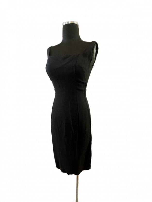 A sexy little black dress vintage 1950s sheath displayed on a mannequin dummy.