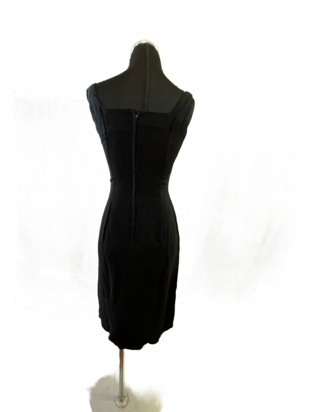 A Sexy little black dress vintage 1950s sheath displayed on a mannequin.