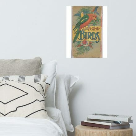 A bedroom with a bed, pillows, and an ABC Book of Birds - Cover Print.